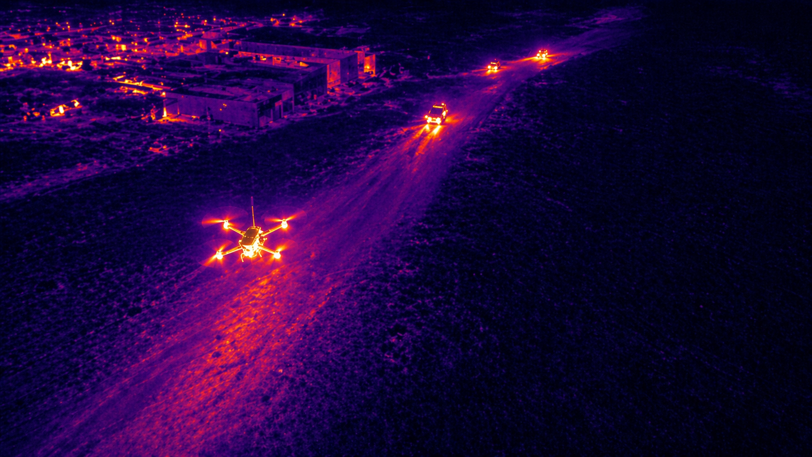 Thermal aerial reconnaissance scene showing terrain and activity from above